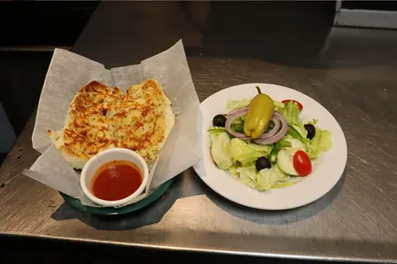 Garlic bread and marinara with a side salad